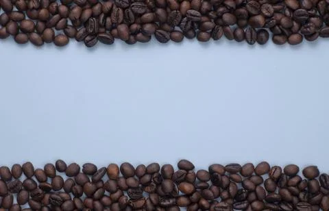 Roasted Coffee Beans Frame on Blue Background with Copy Space Stock Photos