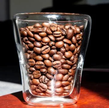 Roasted coffee beans in a glass for breakfast Stock Photos