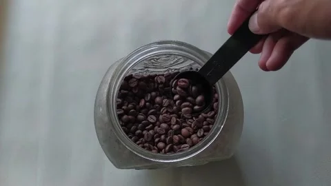 Roasted Coffee Beans in Glass Container Overhead Stock Footage 328418739