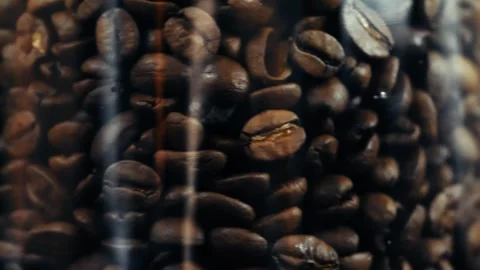 Roasted coffee beans in a glass jar texture rotating macro footage 4k Stock Footage 252030262
