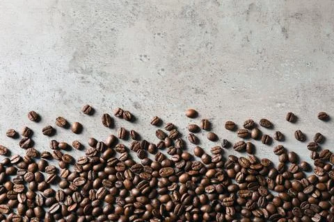 Roasted coffee beans on grey background with space for text, top view Stock Photos