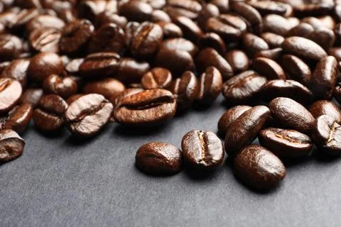 Roasted coffee beans on grey background, closeup Stock Photos