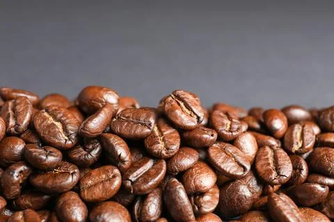 Roasted coffee beans on grey background, closeup 写真素材
