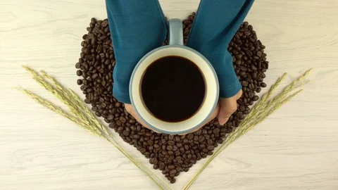 Roasted coffee beans in heart shape with coffee cup Stock Footage 104807291