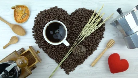 Roasted coffee beans in heart shape with coffee cup Stock Footage 104808353