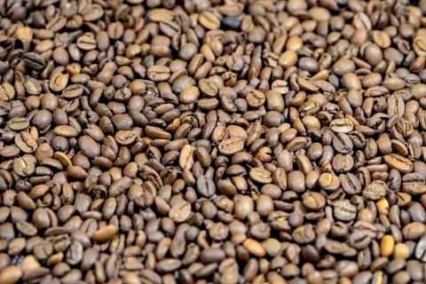 The roasted coffee beans lie on the table. Arab coffee beans. Morning coffee. Stock Photos