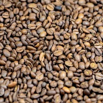 The roasted coffee beans lie on the table. Arab coffee beans. Morning coffee. Stock Photos