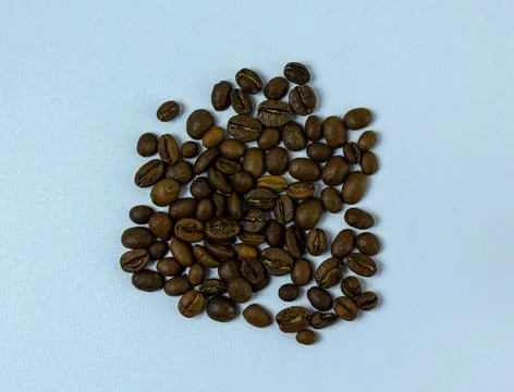 Roasted Coffee Beans On Light Background And Mix Arabica And Robusta Roaste.. Stock Photos