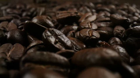 Roasted coffee beans in a macro shot in slowmotion Stock Footage 99059897