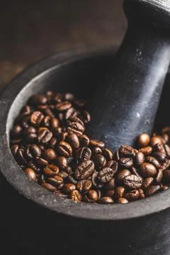 Roasted coffee beans in mortar Stock Photos