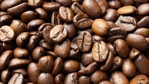 Roasted coffee beans in a motion closeup top view. Stock Footage 273771523