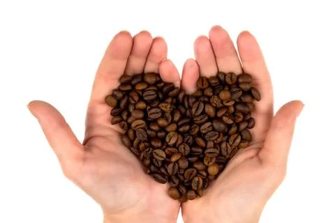 Roasted coffee beans in the palms in the form of a heart  top view Foto stock