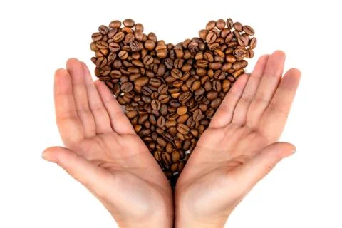 Roasted coffee beans in the palms in the form of a heart  top view Foto stock