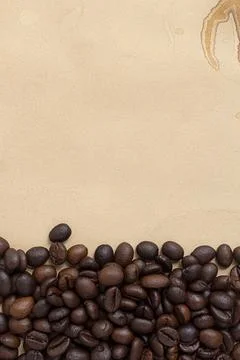 Roasted coffee beans, pattern of coffee beans on brown stain paper background Stock Photos