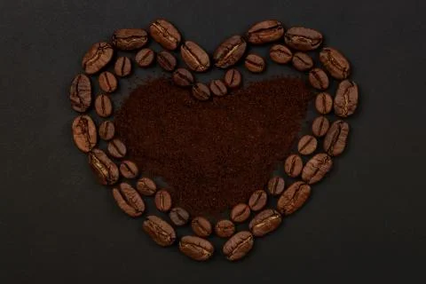 Roasted coffee beans placed in a shape of heart Stock Photos
