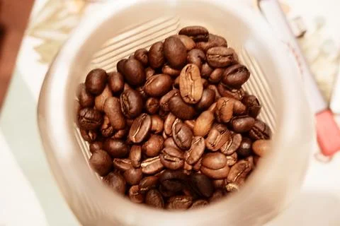 Roasted Coffee Beans in Plastic Container Stock Photos