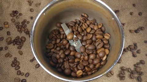 Roasted coffee beans poured into the coffee grinder Stock Footage 75525962