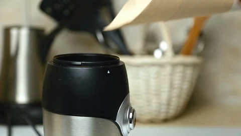 Roasted coffee beans poured into a coffee grinder 库存影片 126766762