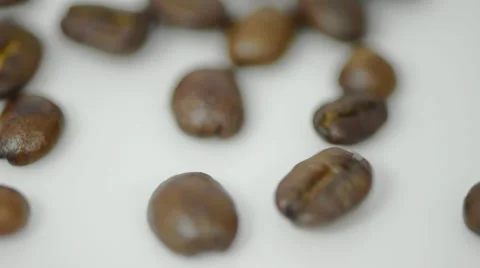 Roasted Coffee beans poured on white background Stock Footage 60119318
