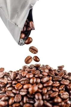 Roasted coffee beans pouring out from the pack. Stock Photos