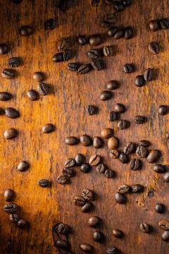 Roasted coffee beans. Roasted coffee beans on wooden table. Top view. Copy... Stock-Fotos
