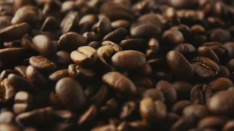 Roasted coffee beans rotate and pour. Side view. Stock Footage 268302897