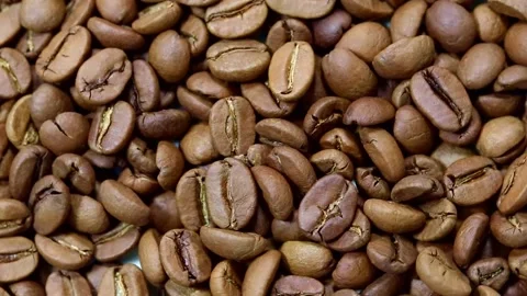Roasted coffee beans rotate around their axis. Top view. Stock Footage 203894911