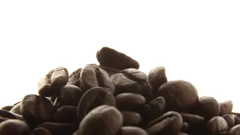 Roasted coffee beans rotate on a white background. Stock Footage 189778665