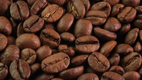 Roasted coffee beans rotating as background close-up macro top view. Concept for Stock Footage 308324772