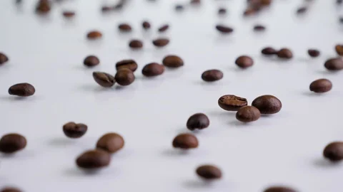Roasted coffee beans rotating on a white background. Stock Footage 129592917