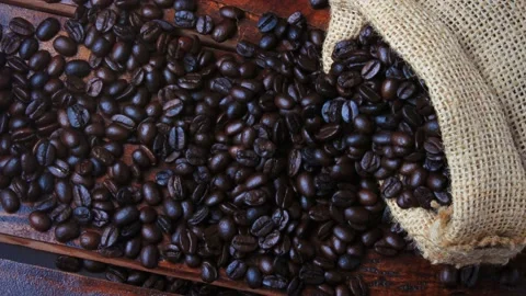 Roasted coffee beans rotation motion over rustic wooden table Stock Footage 195031544