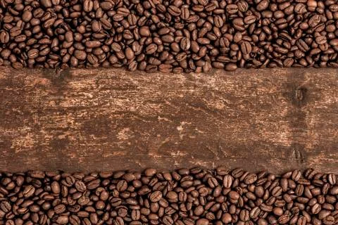 Roasted coffee beans on a rustic old wooden table Stock Photos
