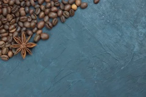 Roasted coffee beans scattering in the corner of the background. beans on a d Stock Photos
