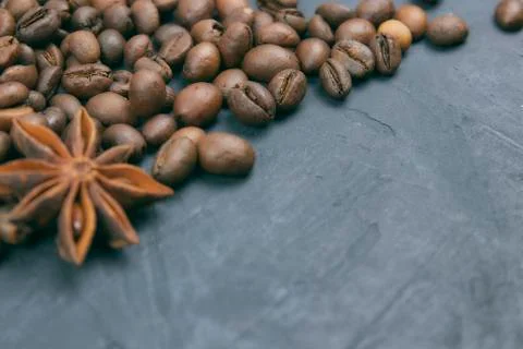 Roasted coffee beans scattering in the corner of the background. beans on a d Stock Photos