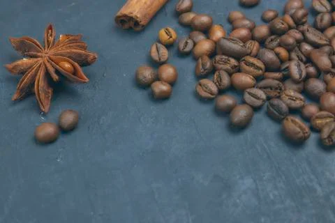 Roasted coffee beans scattering in the corner of the background. beans on a d Stock Photos