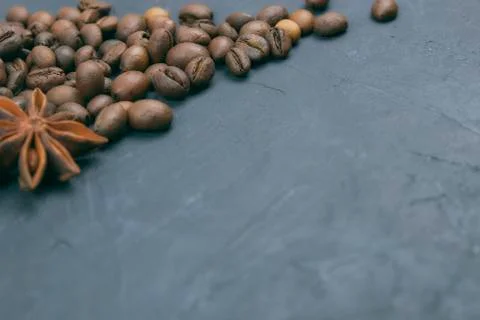 Roasted coffee beans scattering in the corner of the background. beans on a d Stock Photos