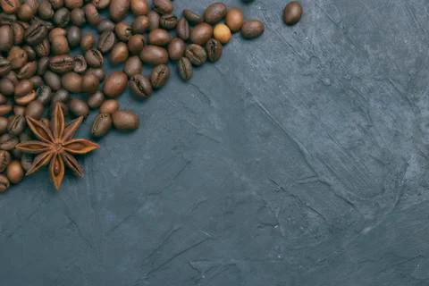 Roasted coffee beans scattering in the corner of the background. beans on a d Stock Photos