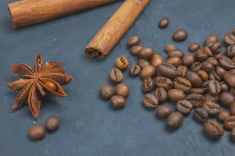 Roasted coffee beans scattering in the corner of the background. beans on a d Stock Photos