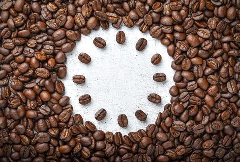 Roasted coffee beans in the shape of Clock. Coffee time concept. Stock Photos