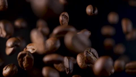 Roasted coffee beans in slow motion. Coffee beans in a free fall. Stock Footage 154208024