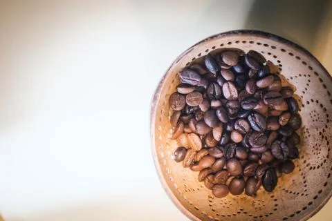 Roasted coffee beans in small individual containers on a rustic in wooden bac Stock Photos