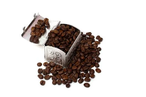 Roasted coffee beans in a small metal chest around it. Isolate on a white bac Stock Photos