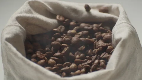 Roasted coffee beans with smoke in a cloth bag. Stock Footage 241357512