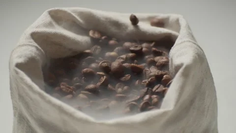 Roasted coffee beans with smoke in a cloth bag. Stock Footage 274062904