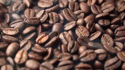 Roasted coffee beans, the smoke comes from the coffee beans. All elements will s Stock Footage 196684821