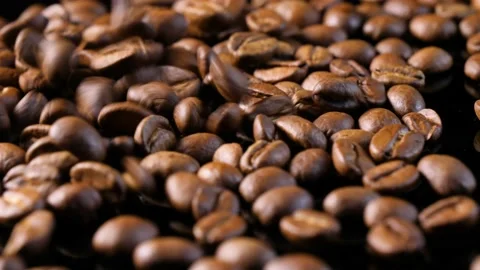 Roasted coffee beans. Smooth motion of arabica coffee seeds. Video stock 154207097