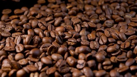 Roasted coffee beans. Smooth motion of arabica coffee seeds. Video stock 154207258