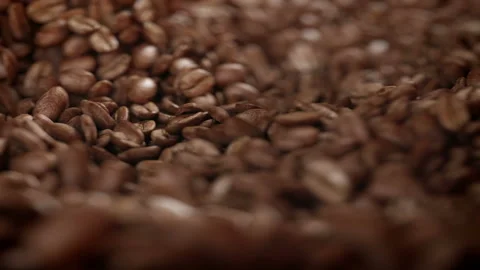 Roasted coffee beans spinning in grinder in 4K Video stock 163665891