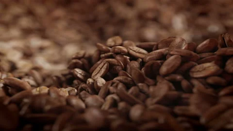 Roasted coffee beans spinning in grinder in 4K Video stock 163802839