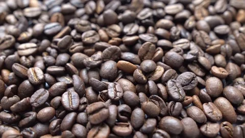 Roasted coffee beans spinning. slow motion. Close up shot. 4k video Stock Footage 247902459